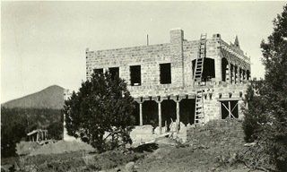 A black and white photo of a building under construction
