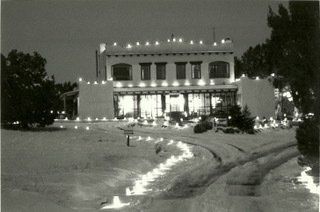 A black and white photo of a house decorated for christmas