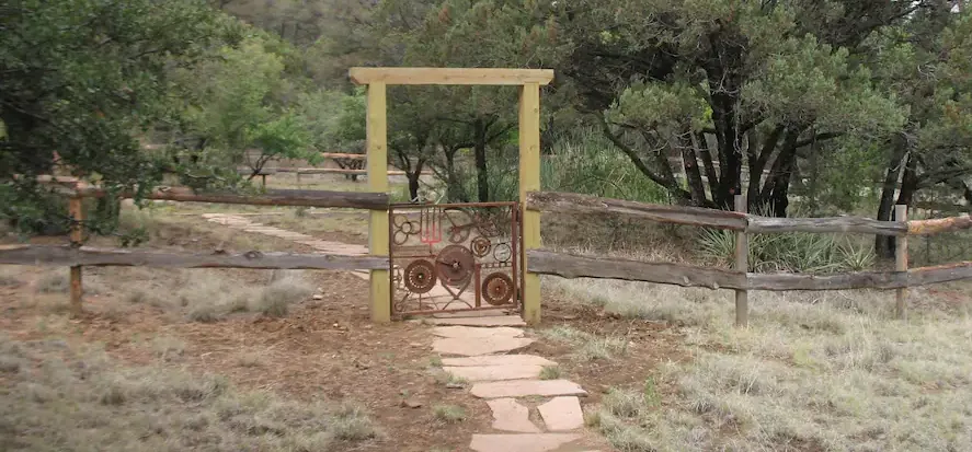 a wooden fence with a yellow gate in the middle of a field .