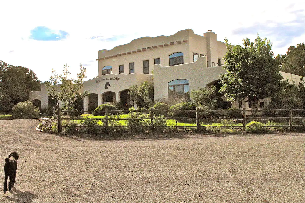 a large white building with a fence in front of it