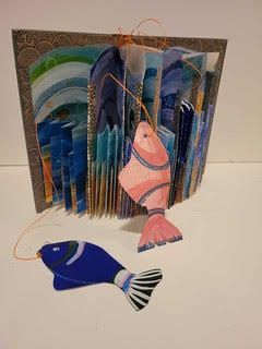 A small brown and white bird perched on a fence post