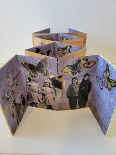 A small brown and white bird perched on a fence post