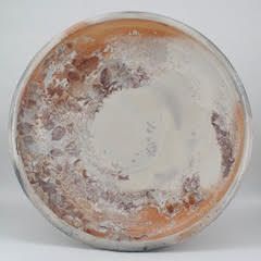 Round ceramic plate with reddish-brown, white, and gray abstract pattern.
