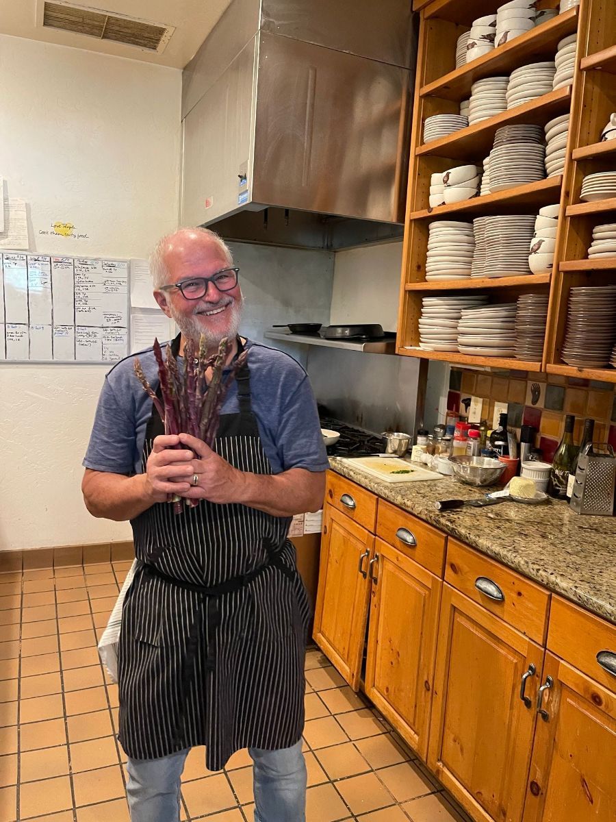 A small yellow flower is growing out of the ground
