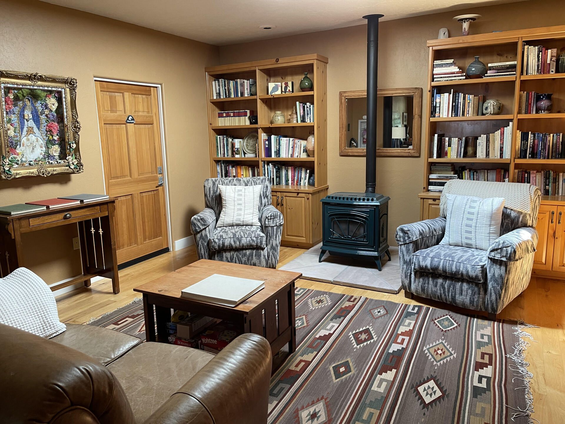A living room filled with furniture and a wood stove
