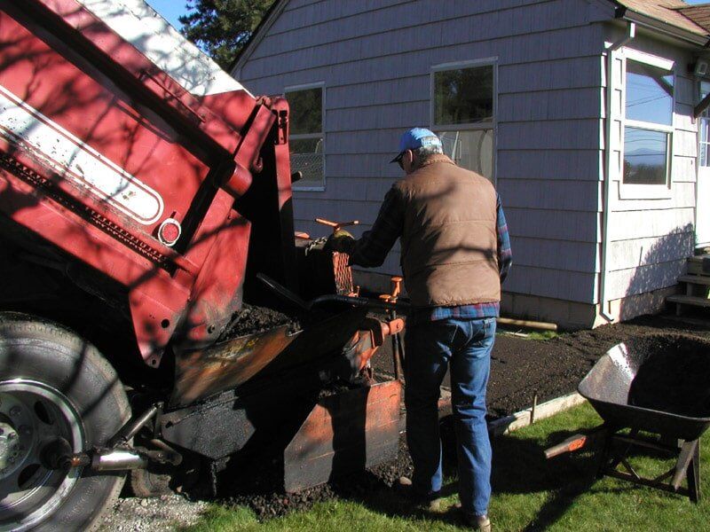 Spreading gravel with paver — Commercial pavers in Clackamas, OR