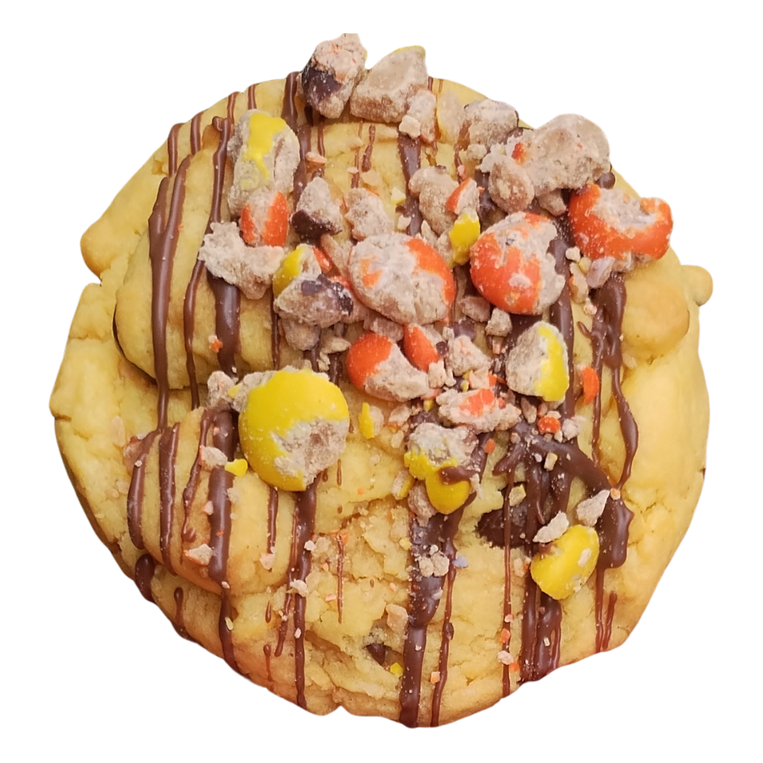 Cookie with chocolate drizzle and Reese's Pieces candy.