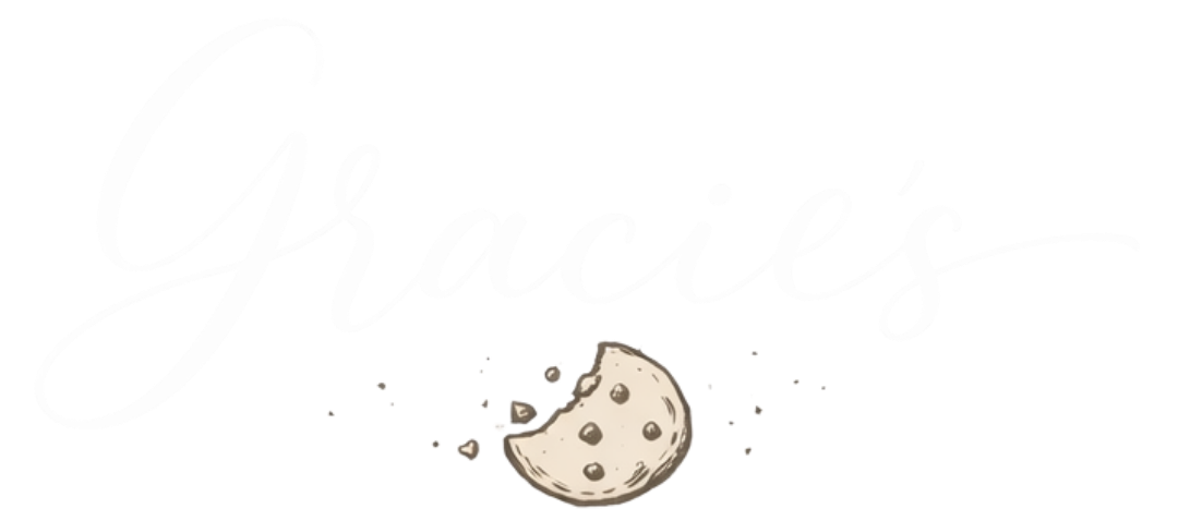 A cookie with a bite taken out, surrounded by crumbs, with the word 