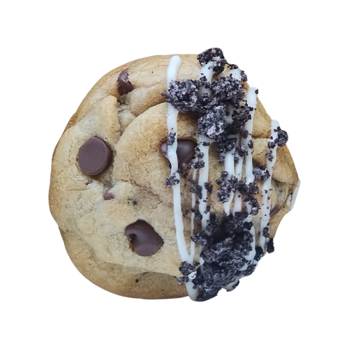 Chocolate chip cookie with white icing drizzle and crushed cookies.