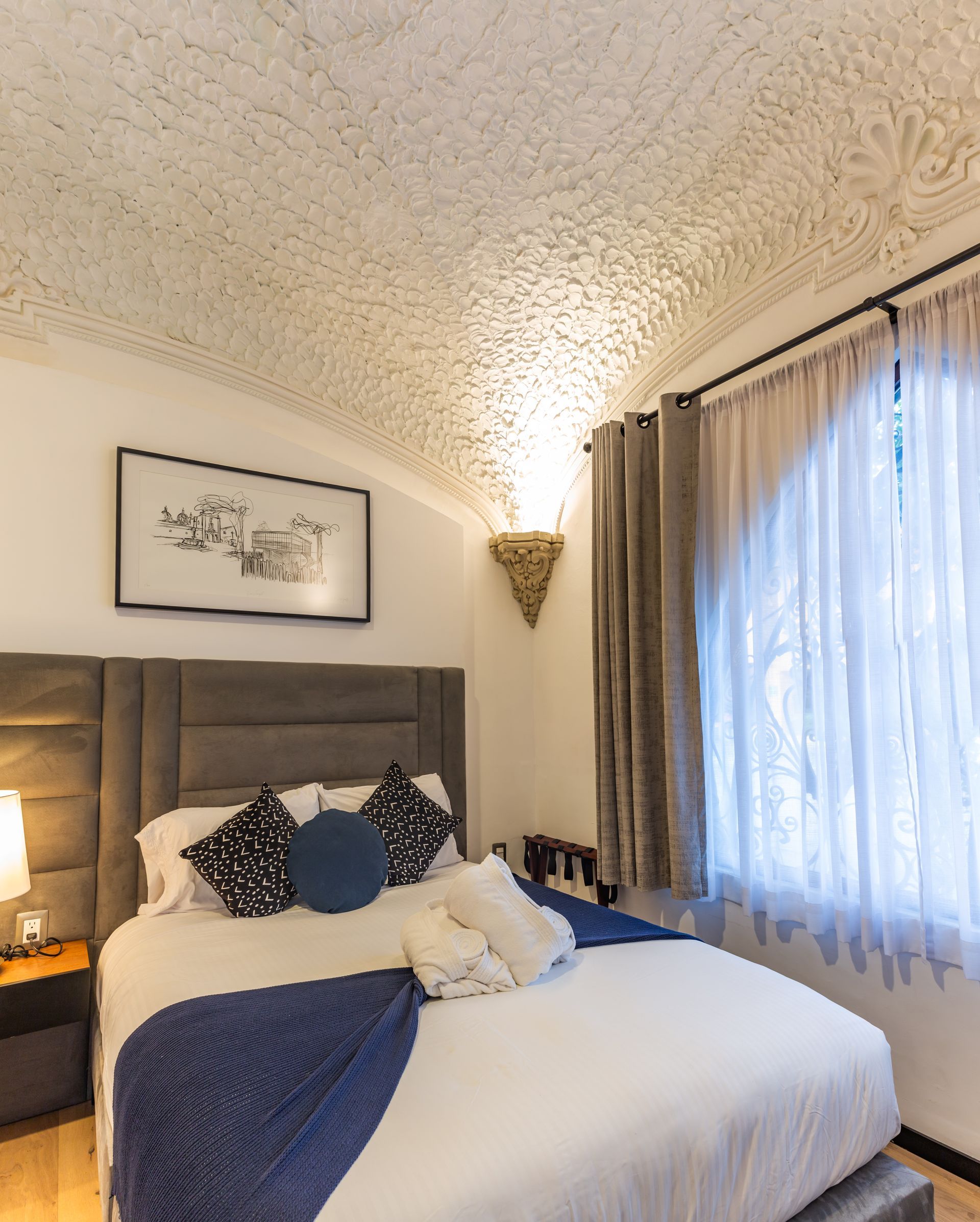 A bedroom with a large bed and a window