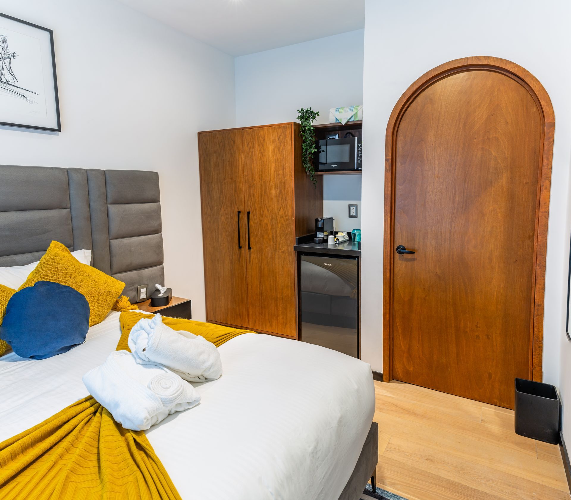 A hotel room with a bed and a door