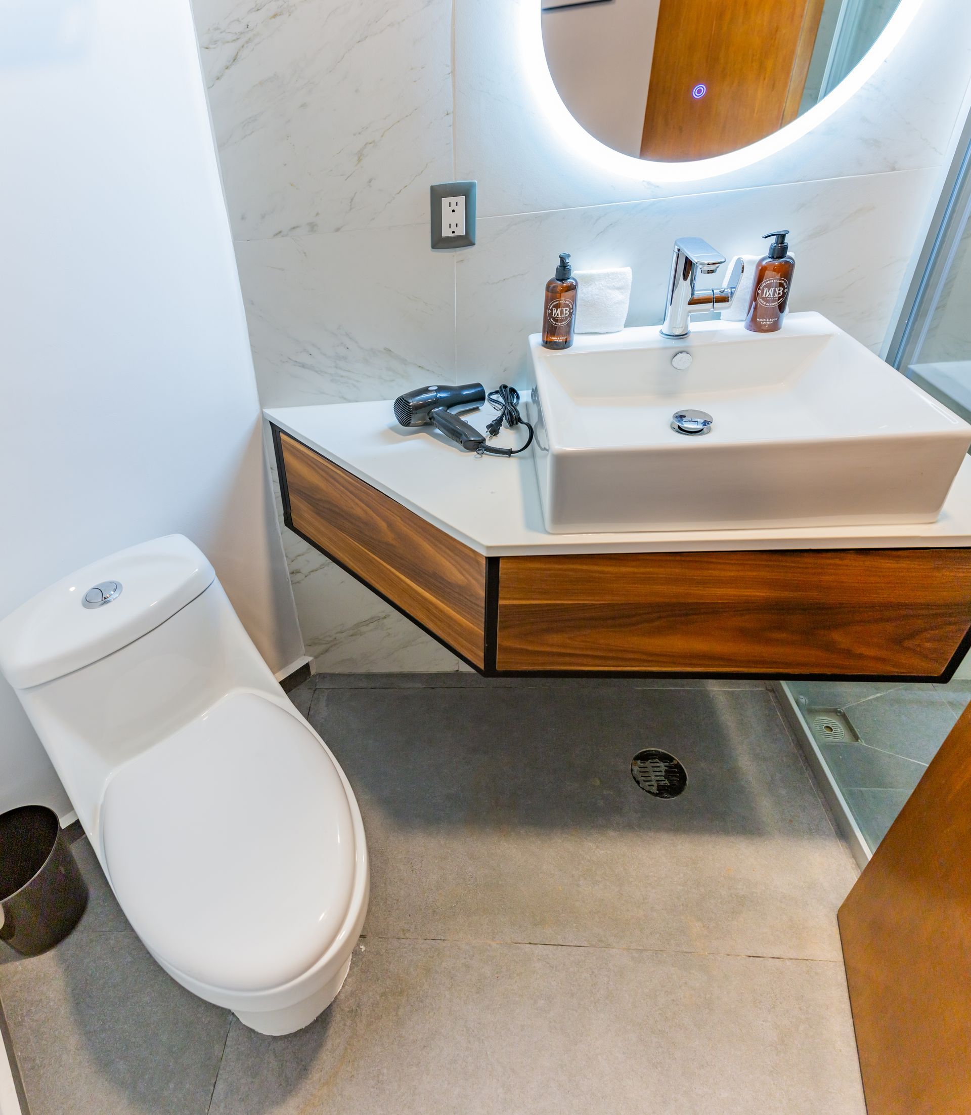 A bathroom with a toilet a sink and a mirror