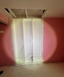 Removing mold from a wall during mold cleanup by PUDDLES Restoration | Ocala, FL