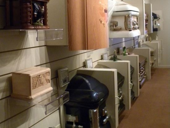 A row of coffins are on display in a store