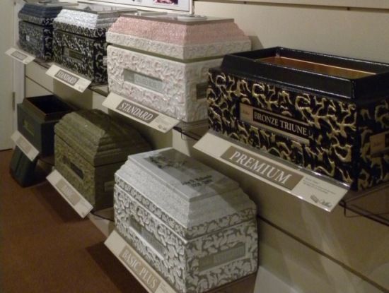A display of coffins with one that says premium on it