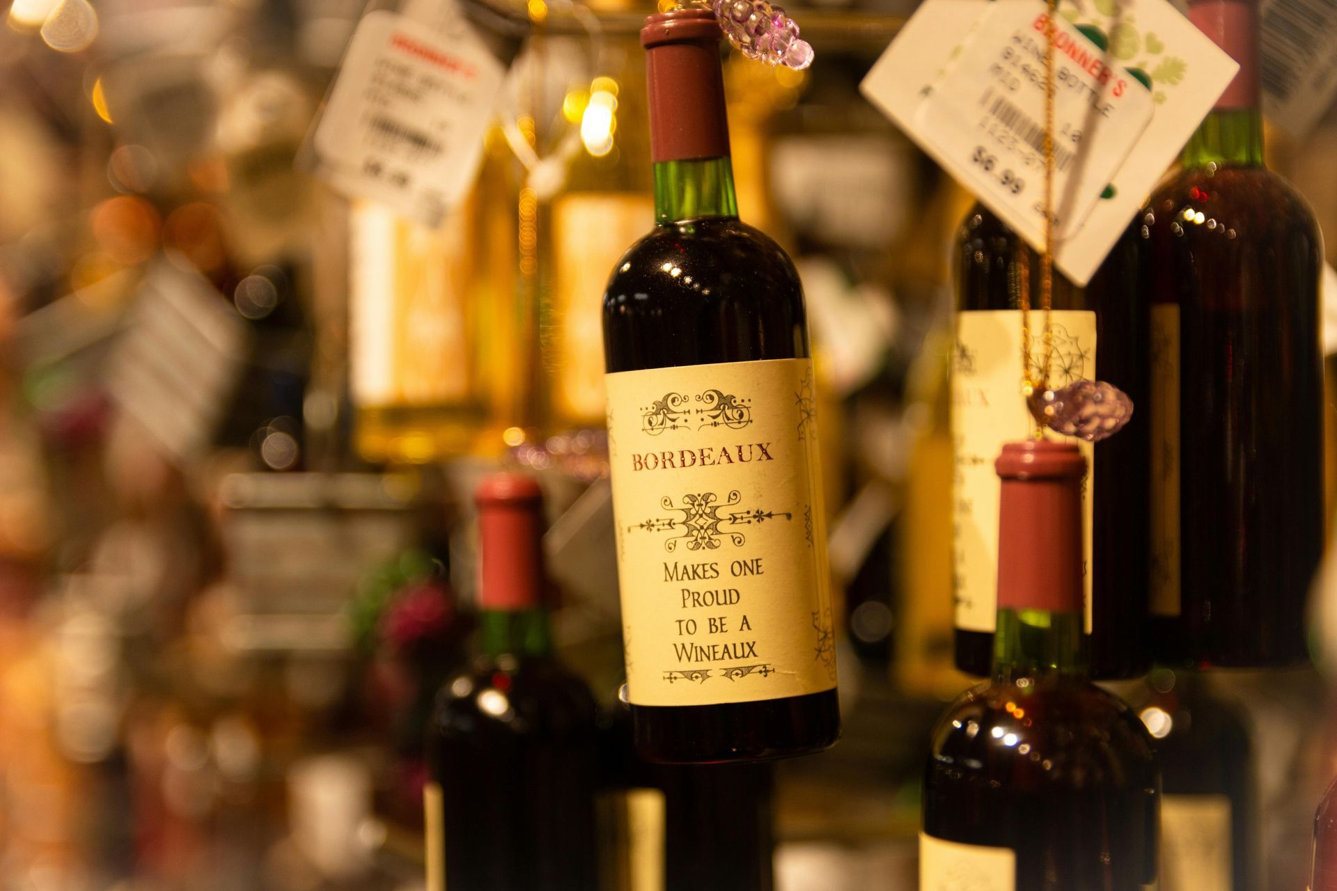 A bottle of bordeaux wine is surrounded by other bottles.