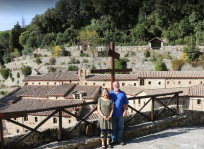 A man and a woman standing in front of a cross A man and a woman standing in front of a cross