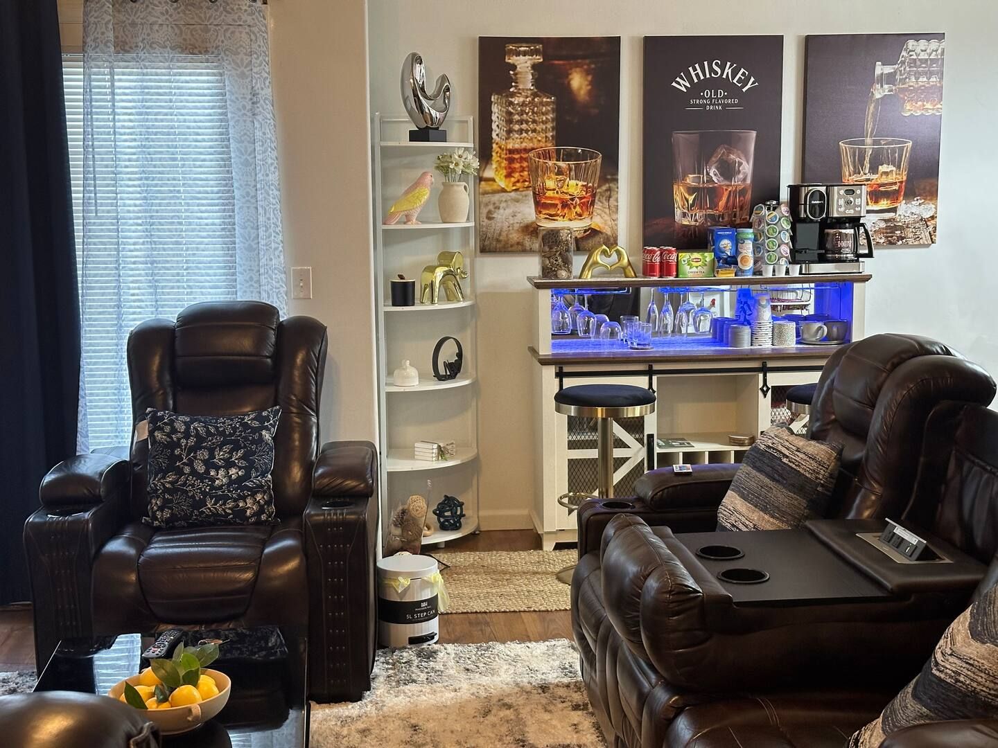 A living room with a couch, chair, table, and a bar.