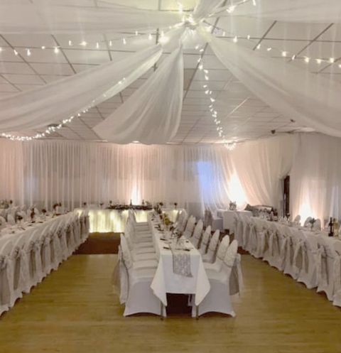 white wedding venue with long tables