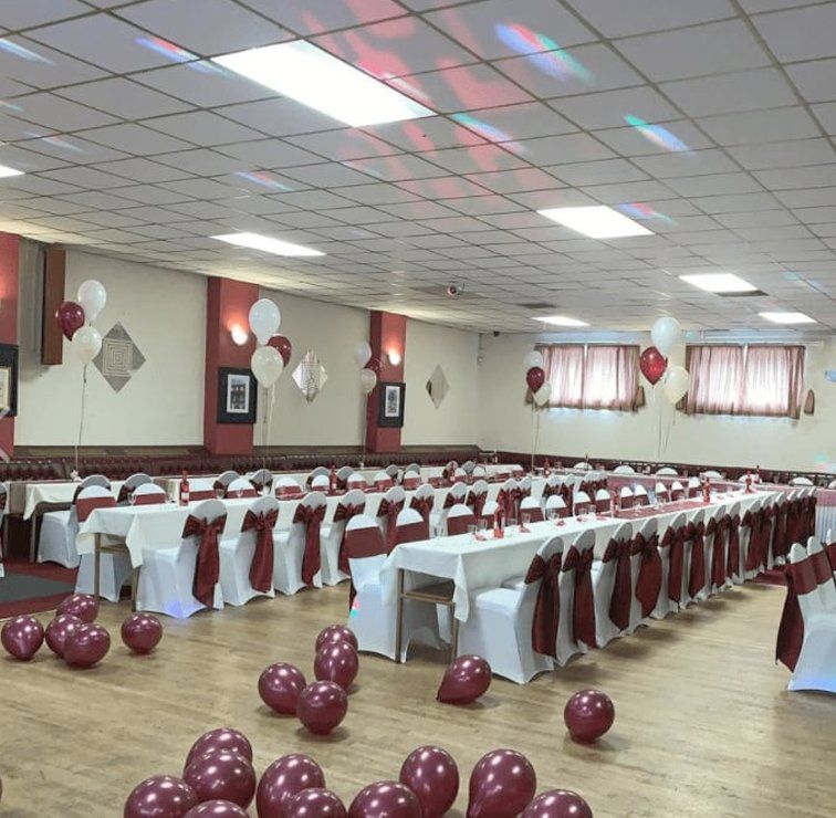 venue with white chairs with red bows