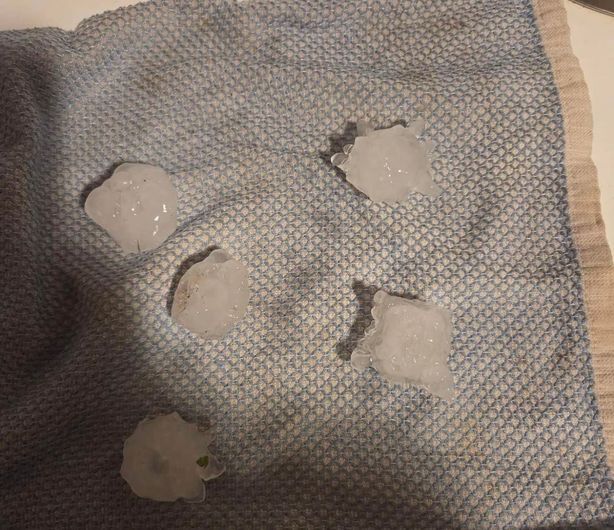A blue cloth with ice cubes on it
