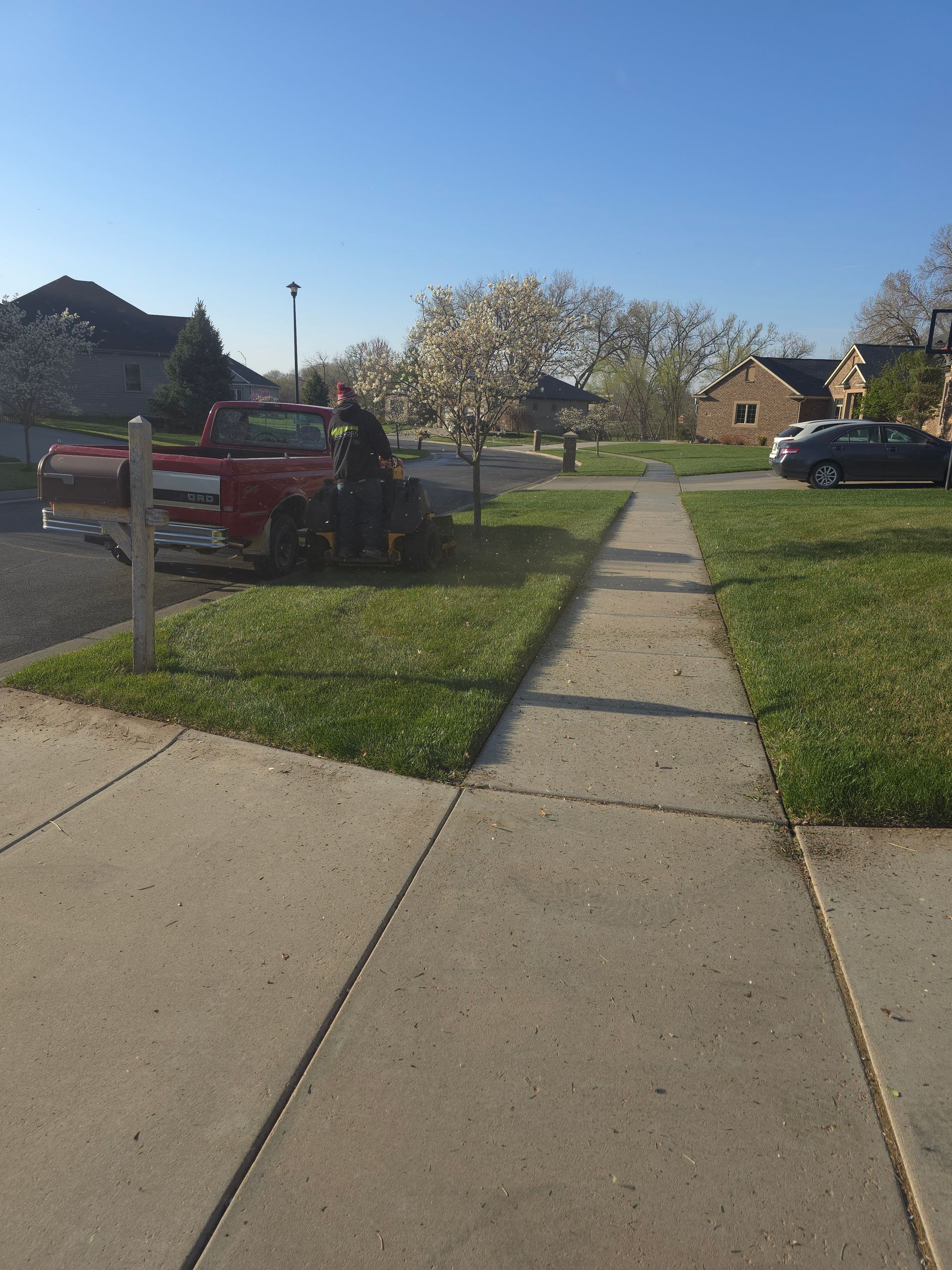 A red truck is parked on the side of the road