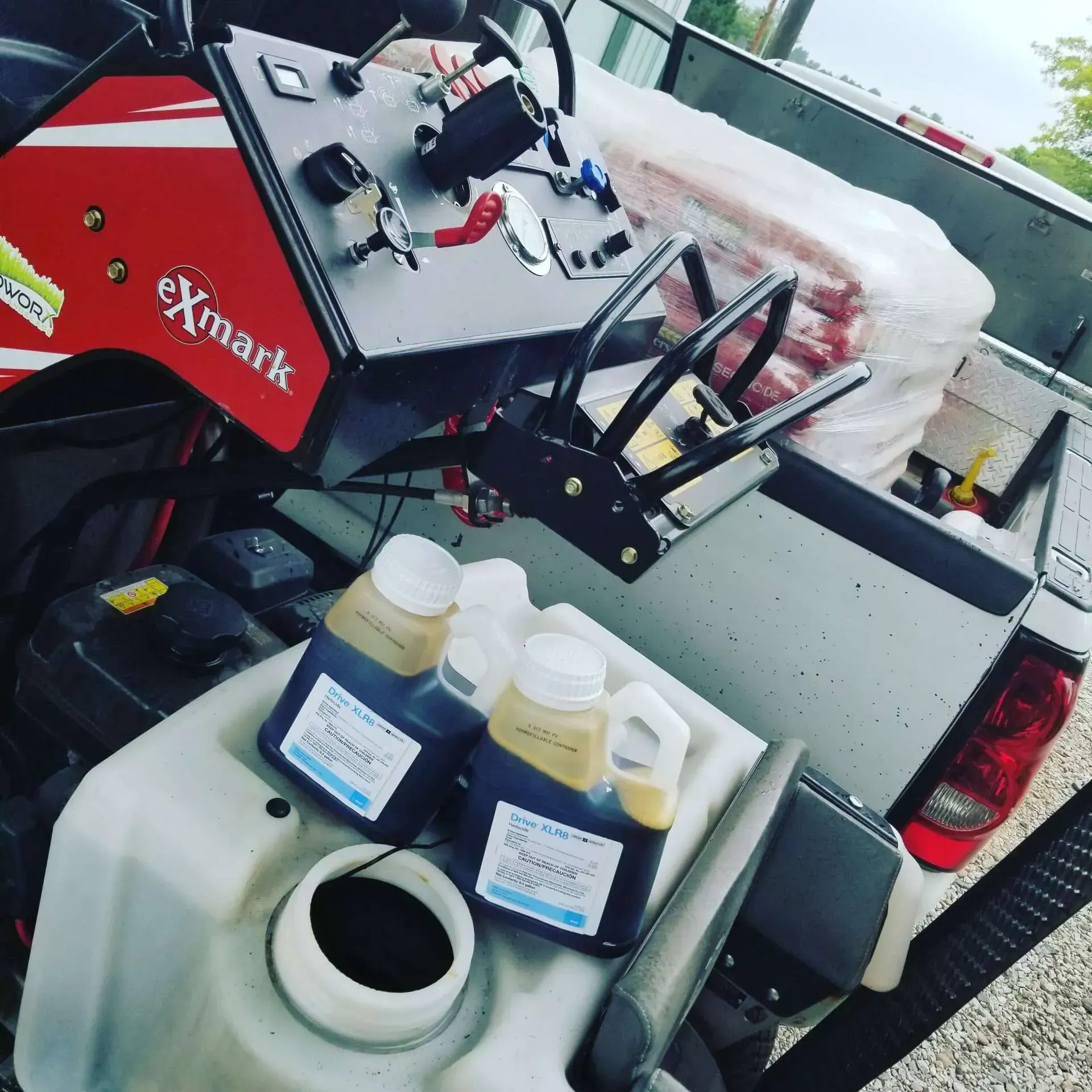 A red and white vehicle with the word exmark on the side