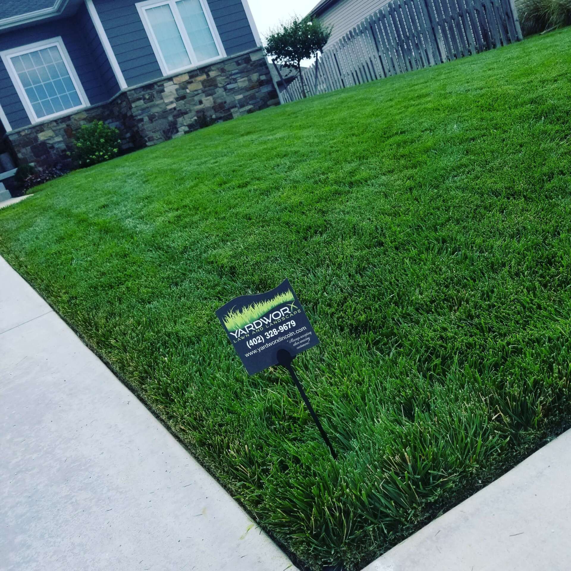 A lush green lawn with a sign in the middle of it