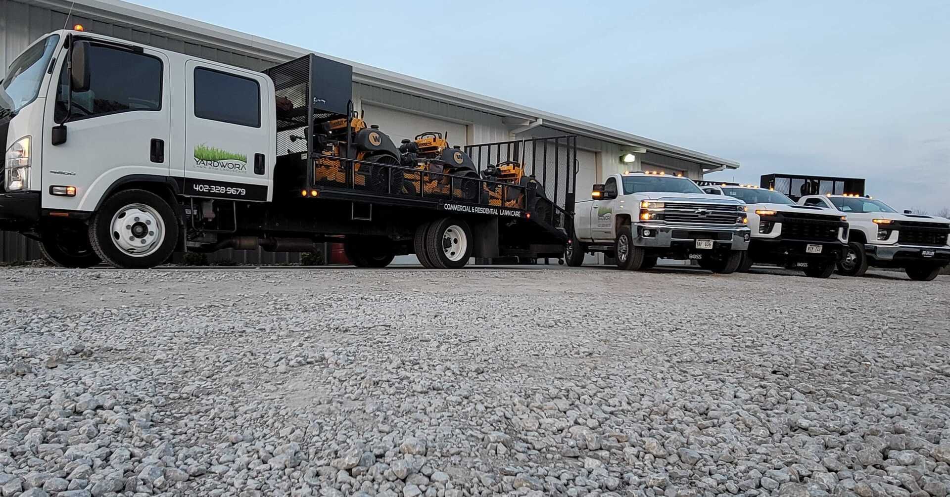A row of trucks are parked in front of a building.