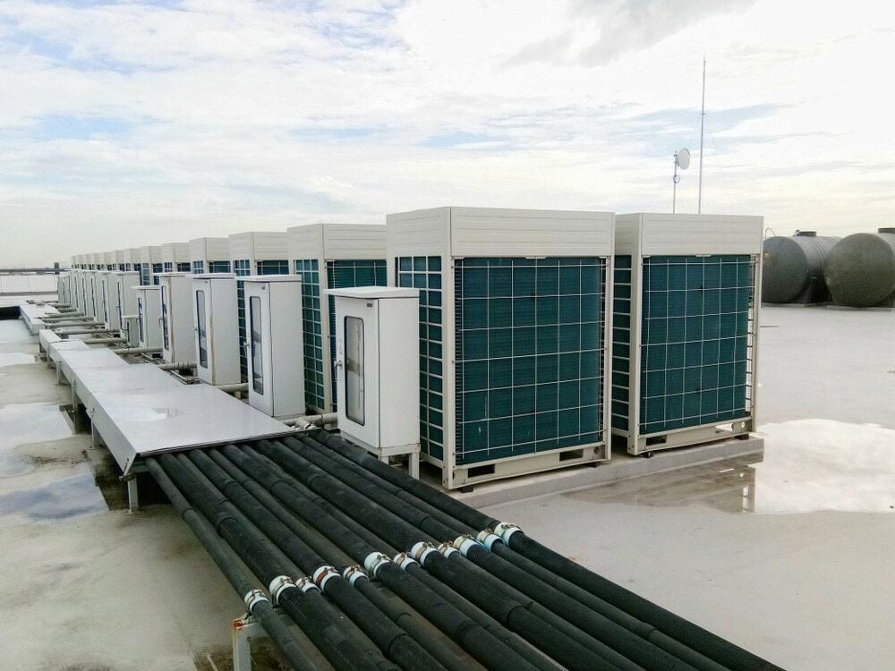 A Row of Air Conditioners Are Sitting on Top of a Roof — AJM's Air Conditioning Centre in Goonellabah, NSW
