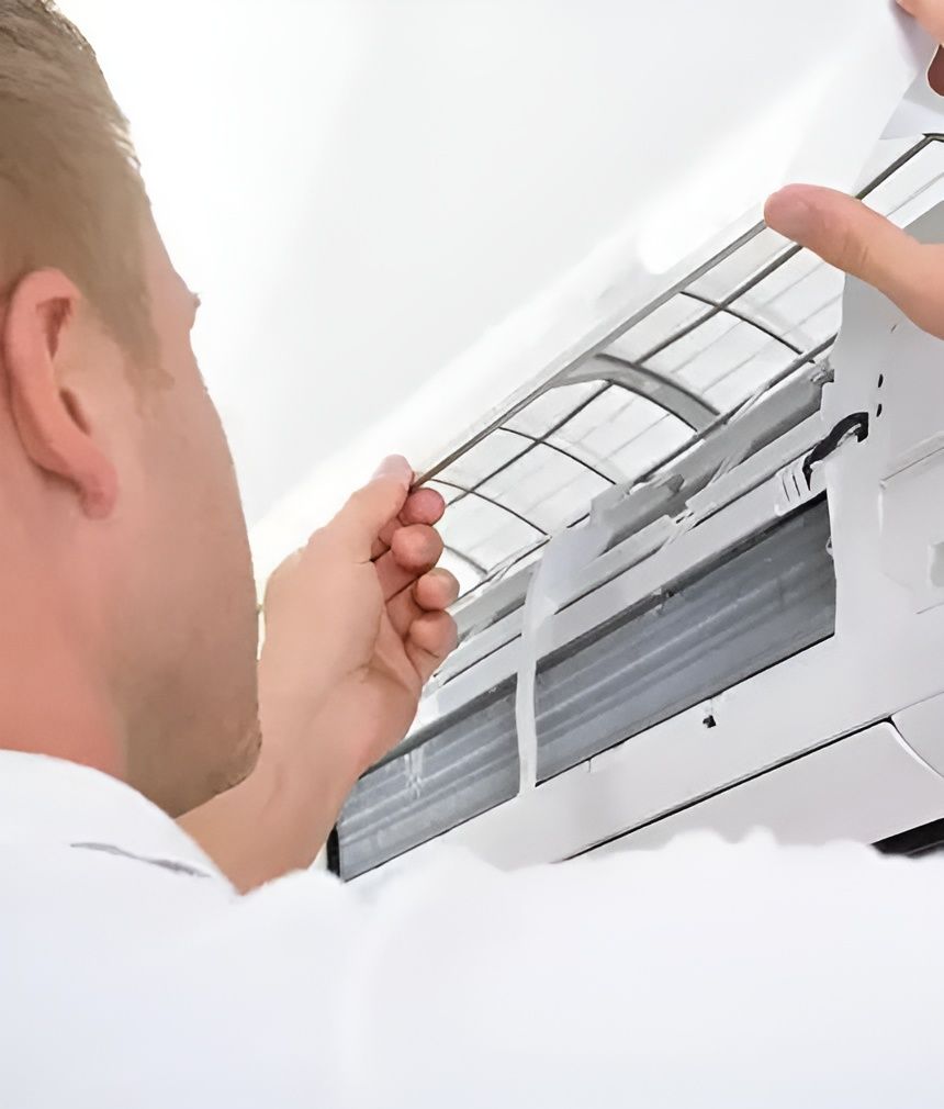 A Man is Cleaning the Filter of an Air Conditioner — AJM's Air Conditioning Centre in Lismore, NSW