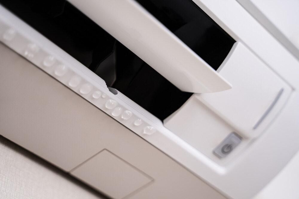 A Close Up of a White Air Conditioner on a Wall — AJM's Air Conditioning Centre in Alstonville, NSW