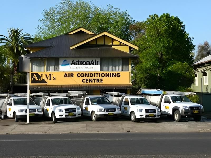 Several Trucks Are Parked in Front of an Actron Air Air Conditioning Centre — AJM's Air Conditioning Centre in Lismore, NSW