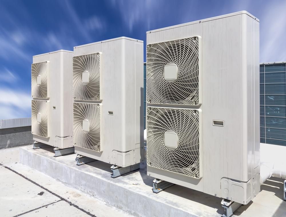 Three Air Conditioners Are Sitting on Top of a Roof — AJM's Air Conditioning Centre in Lismore, NSW