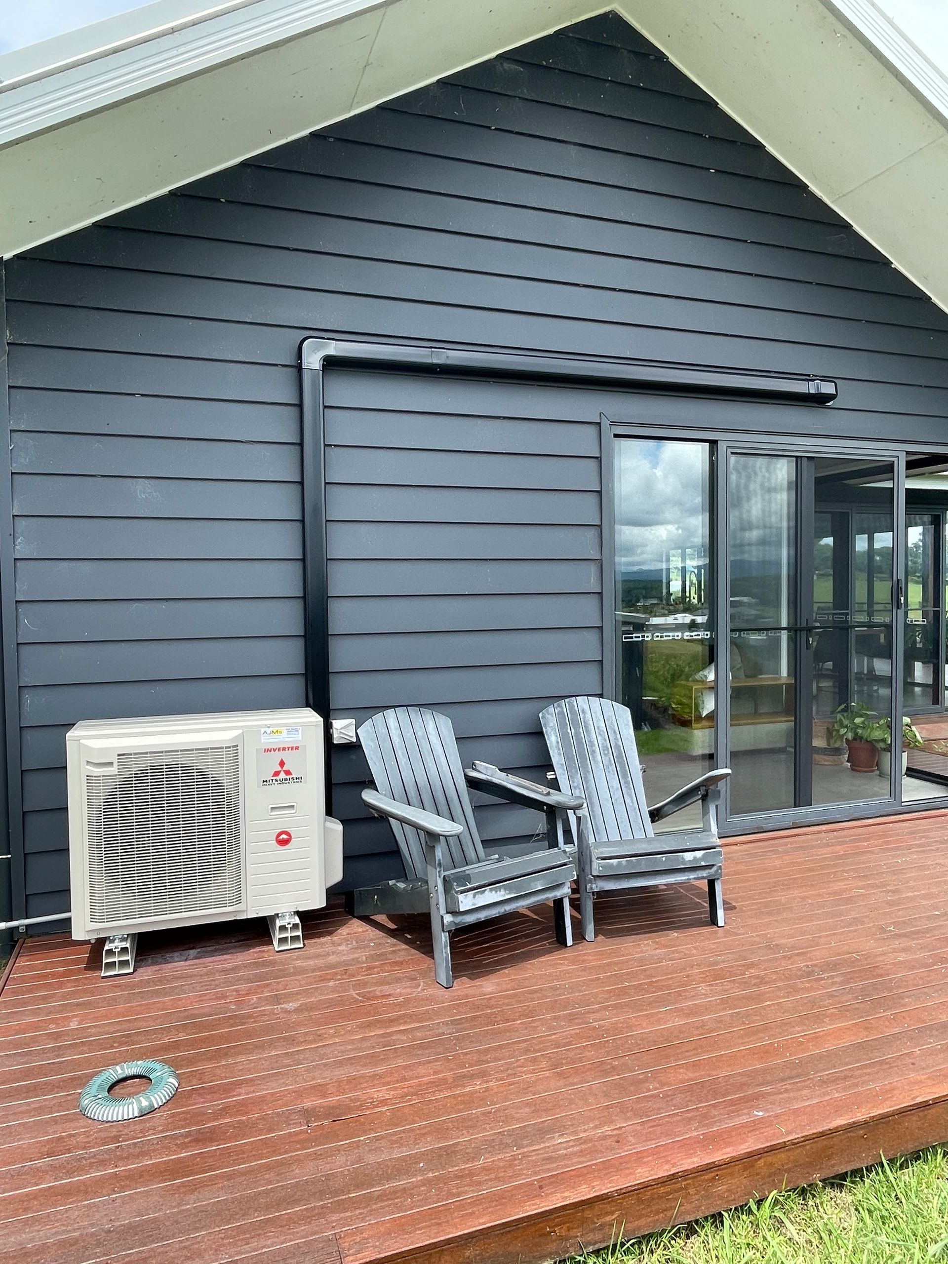 a black house with an outside air con unit outside — AJM's Air Conditioning Centre in Lismore, NSW