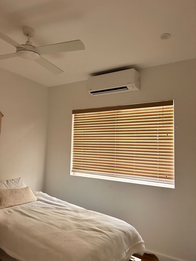 A white room with an air con unit on the wall — AJM's Air Conditioning Centre in Lismore, NSW