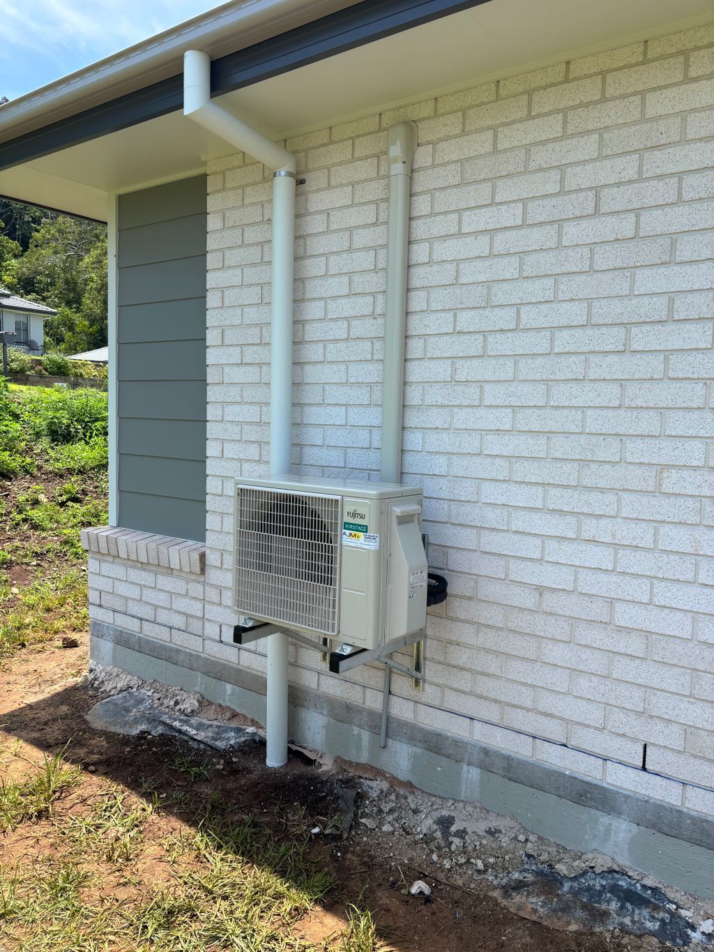 A Rock wall with a hire unit and air con unit — AJM's Air Conditioning Centre in Lismore, NSW