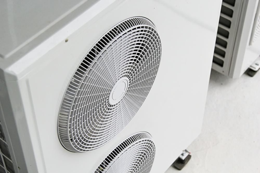 Two Fans Are Sitting Next to Each Other on a White Surface — AJM's Air Conditioning Centre in Wardell, NSW