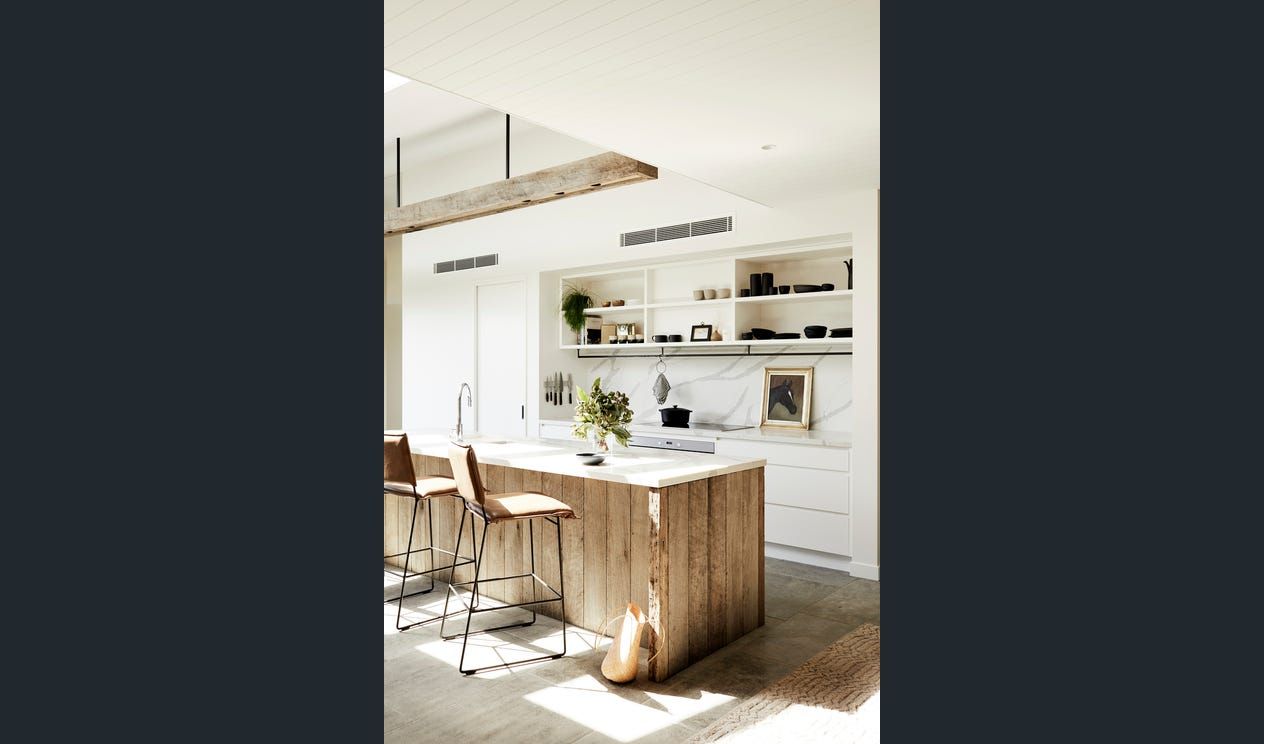 a kitchen island with stools and wooden cupboard — AJM's Air Conditioning Centre in Lismore, NSW