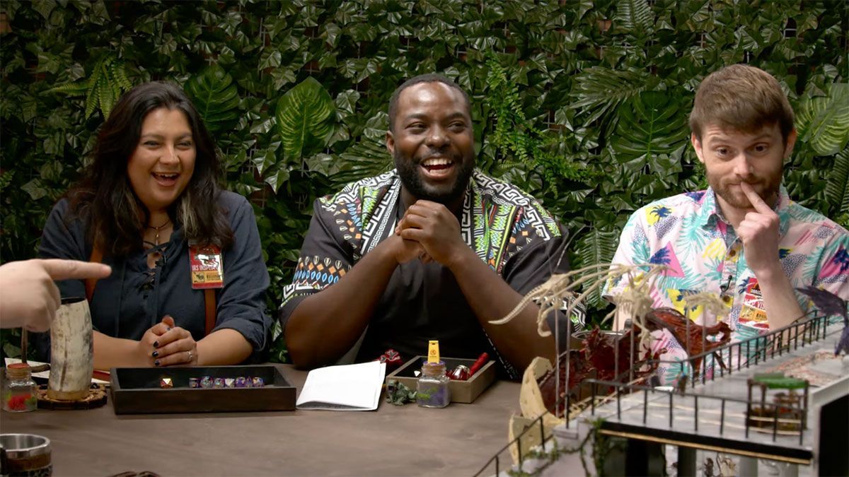 A group of people are sitting at a table playing a game.
