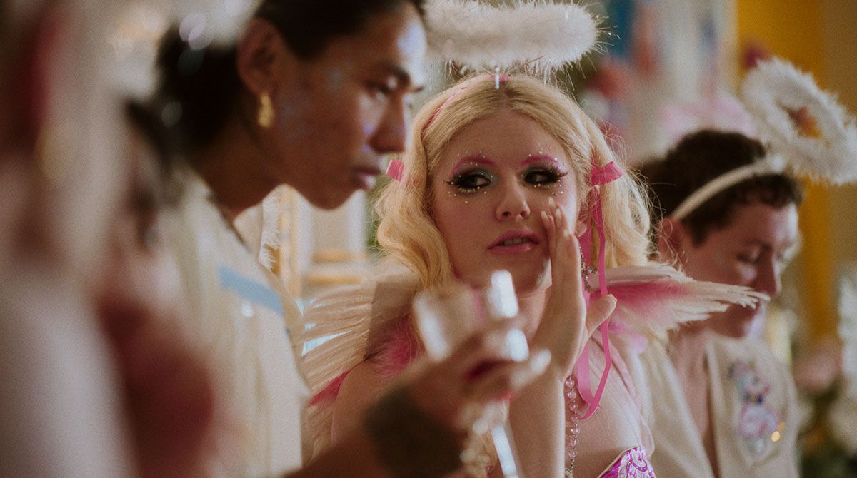 A group of girls dressed as fairy dolls are sitting at a table.