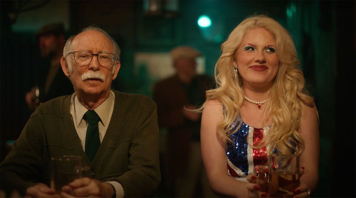 A man and a woman are sitting next to each other in a bar.