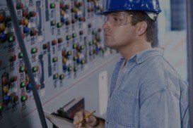 Mid adult man standing in the control room writing on a clipboard Credit - Electrical in Cheyenne, WY
