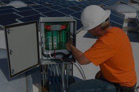 Electrical Engineer Among Solar Panels at Solar Power Plant - Electrical Maintenance in Cheyenne, WY