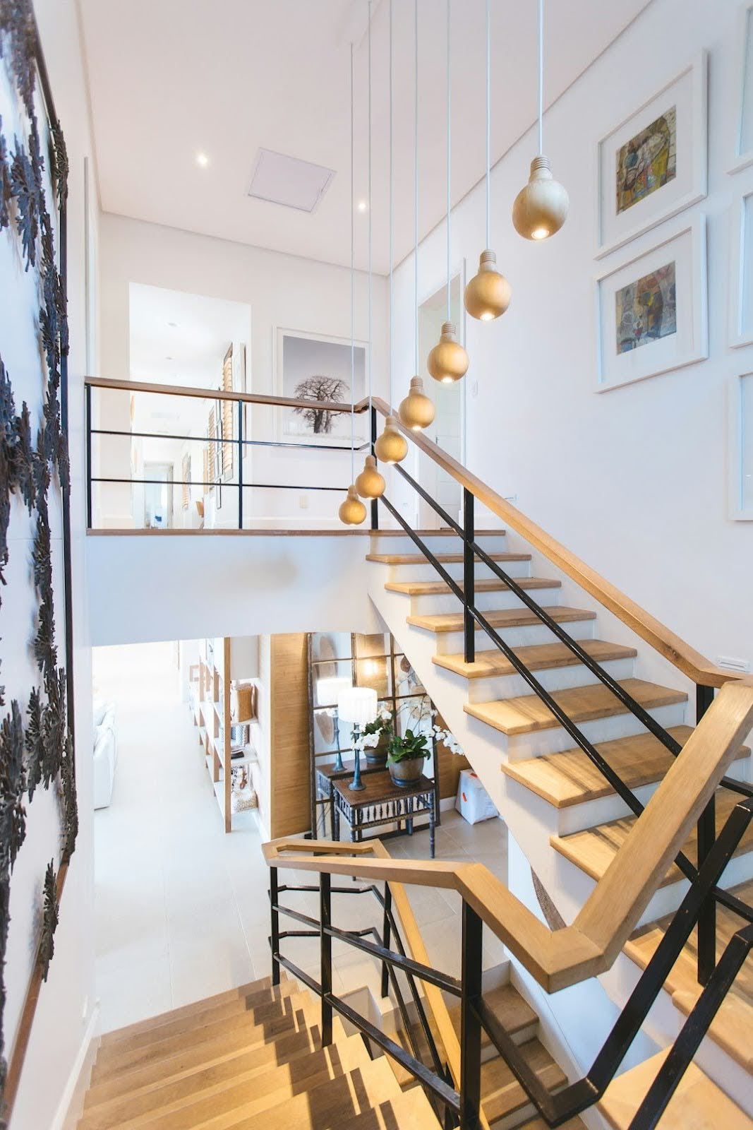 A staircase with wooden steps and a metal railing in a house.