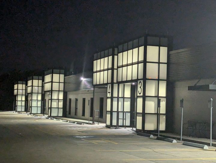 A large building with a lot of windows and a fire hydrant in front of it.