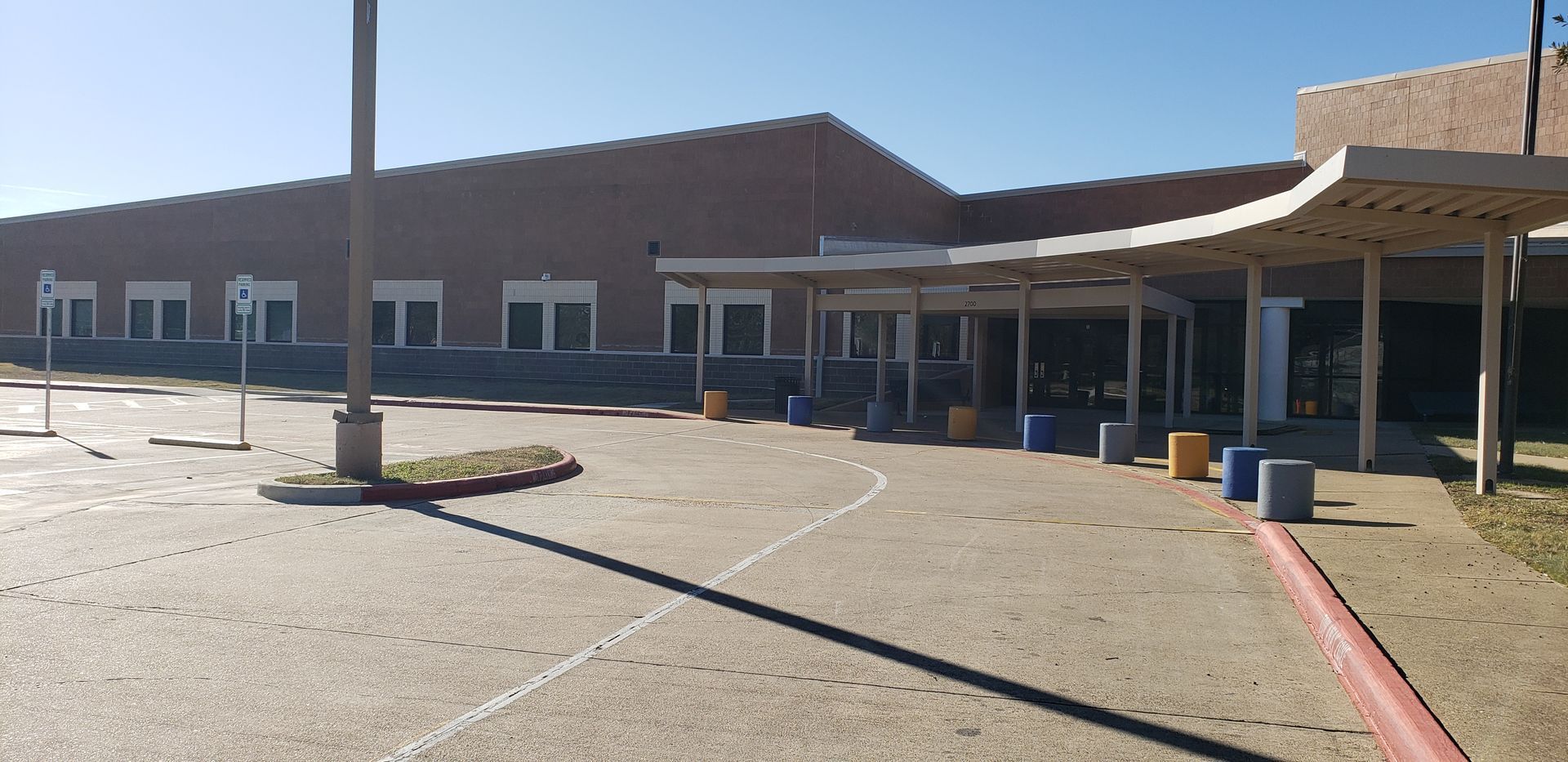 A large brick building with a covered walkway in front of it