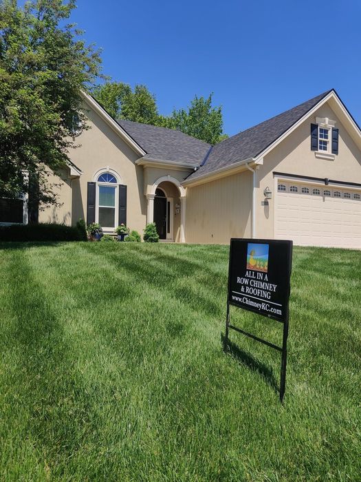 A house with a for sale sign in front of it.