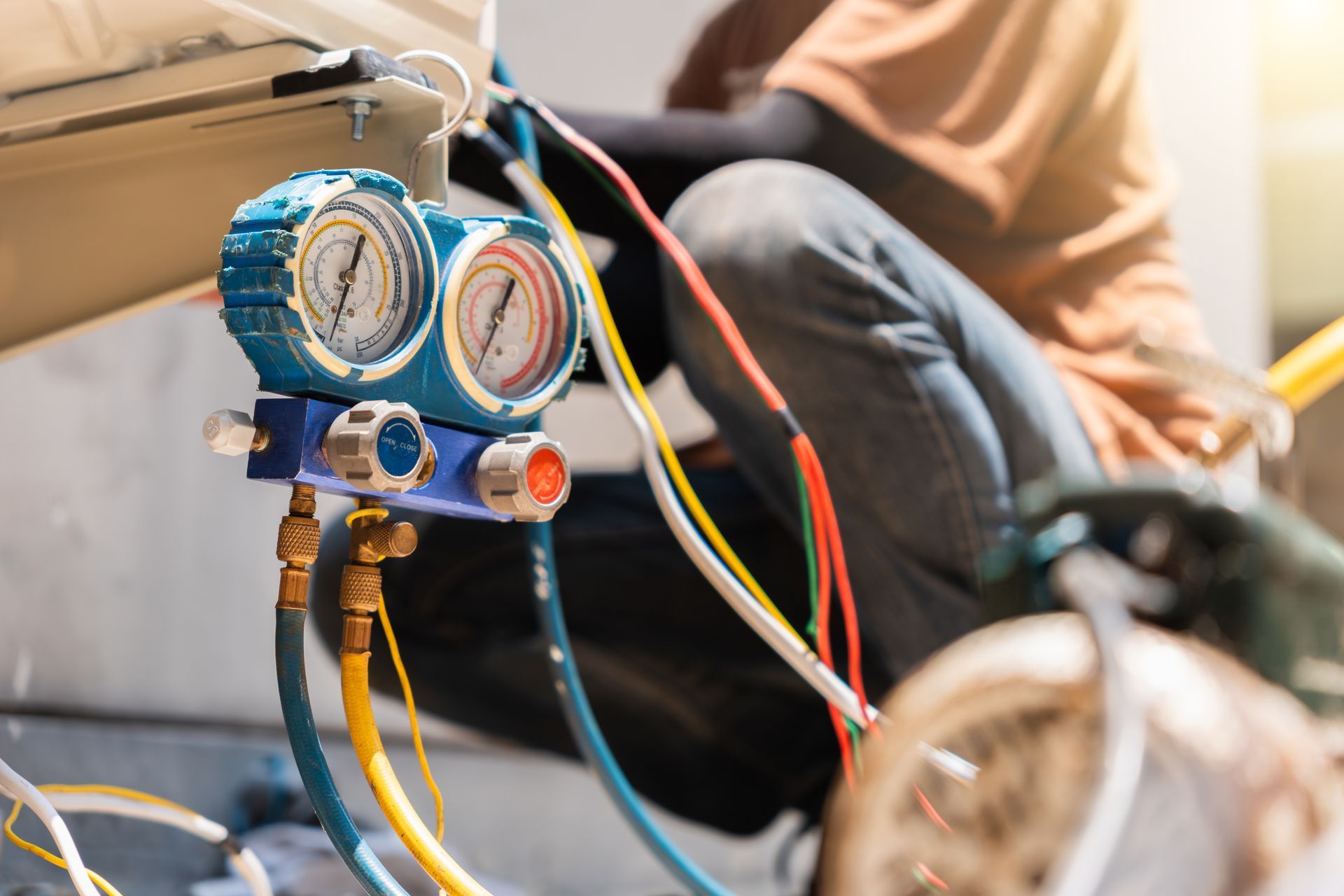 HVAC connected to hoses used for measuring refrigerant pressure during air conditioning maintenance. HVAC connected to hoses used for measuring refrigerant pressure during air conditioning maintenance.