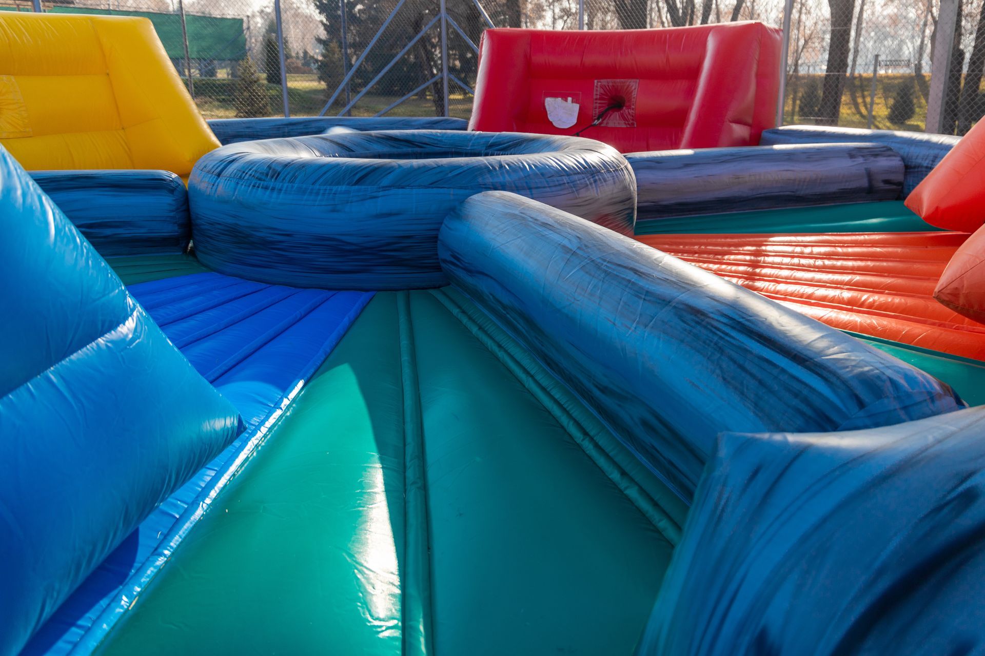 Colorful inflatable obstacle course outdoors.